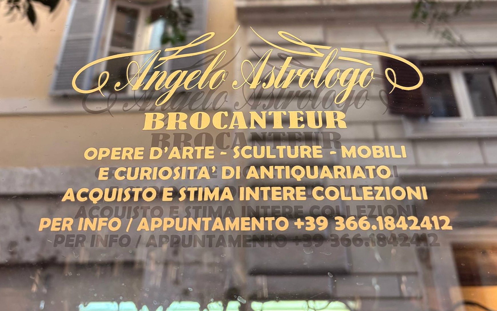 The shop window with its gold lettering, reflecting the houses of Via dei Banchi Nuovi